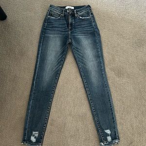 Size 7/27 KanCan skinny jeans. Darker wash, no distressing other than frayed hem